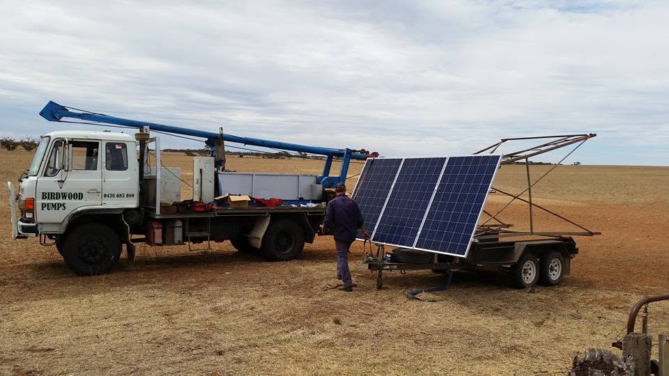 Birdwood Pumps service truck and crew setting up a solar pumping array